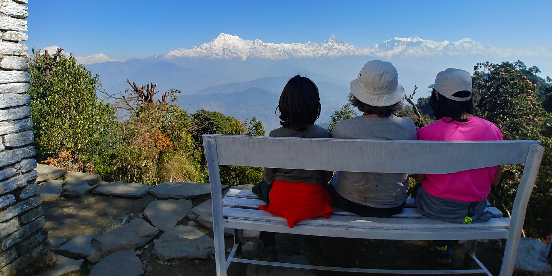 Trekkers enjoying the view of Dhaulagiri and the Annapurnas from Panchase top on the Panchase trek in Nepal